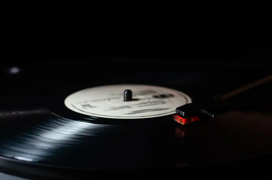 Vintage vinyl record on turntable with stylus close-up, perfect for music lovers.