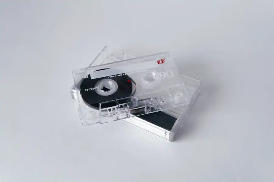 Vintage cassette tapes stacked on a white background, evoking nostalgia and classic music vibes.