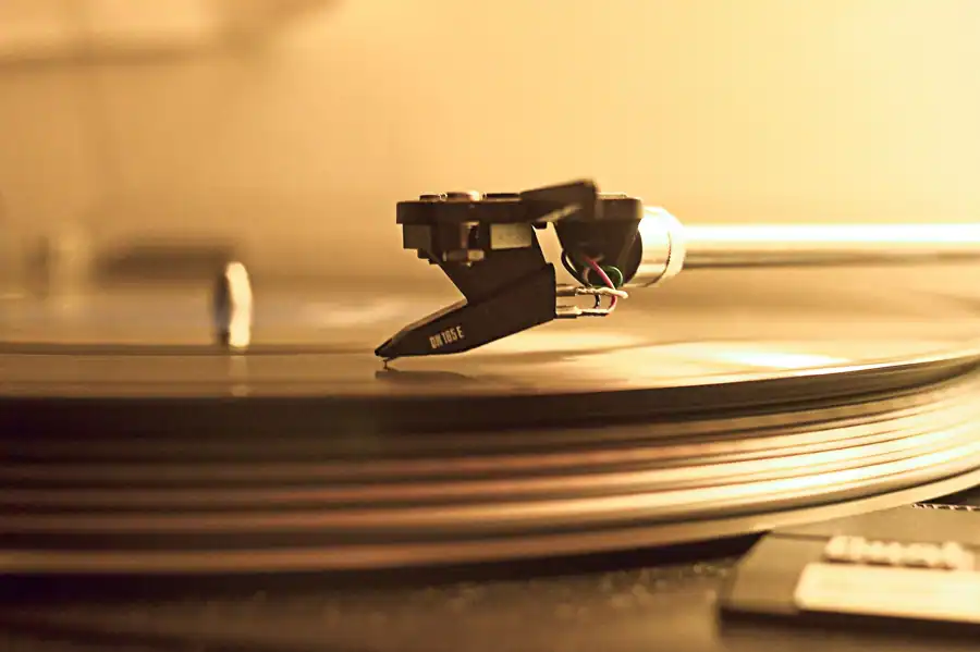 A classic gramophone needle playing a vinyl record, capturing nostalgia and retro vibes.